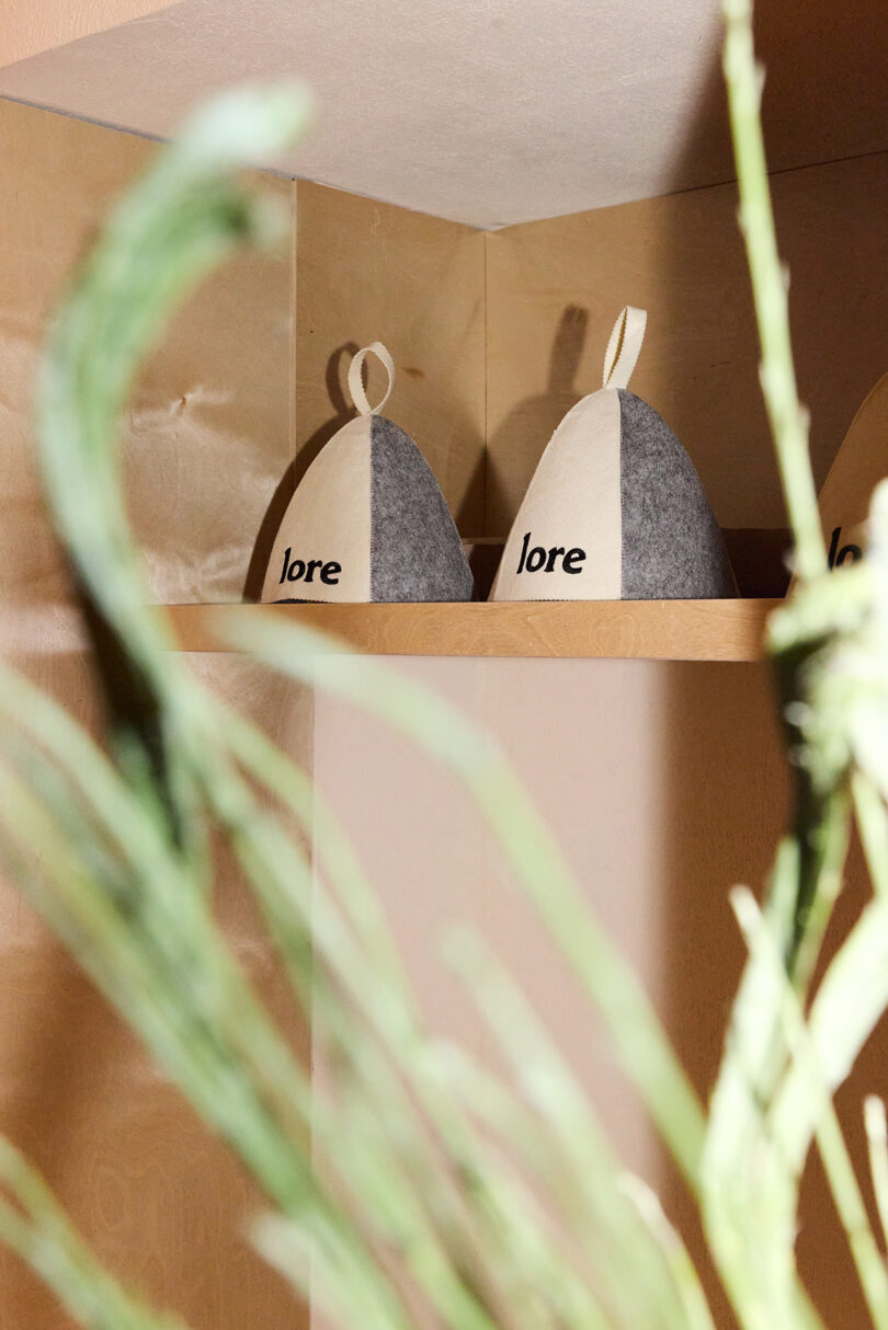 Two gray and white felt hats labeled 