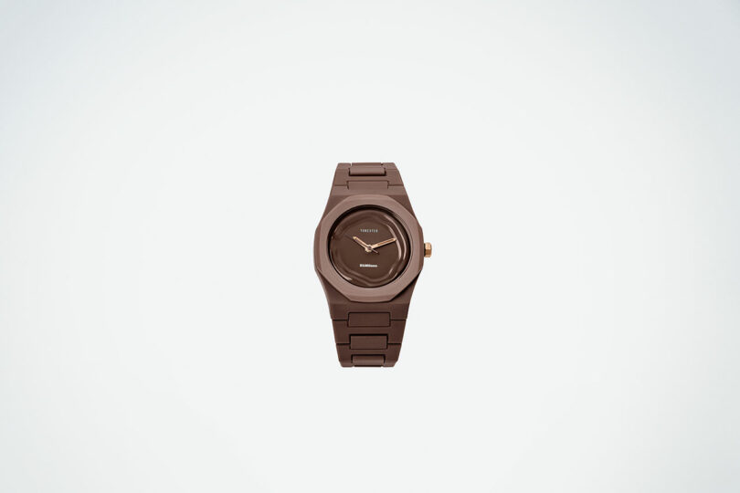 A brown wristwatch with a matching brown band, round face, and gold crown, displaying the time at 10:10 against a plain white background.