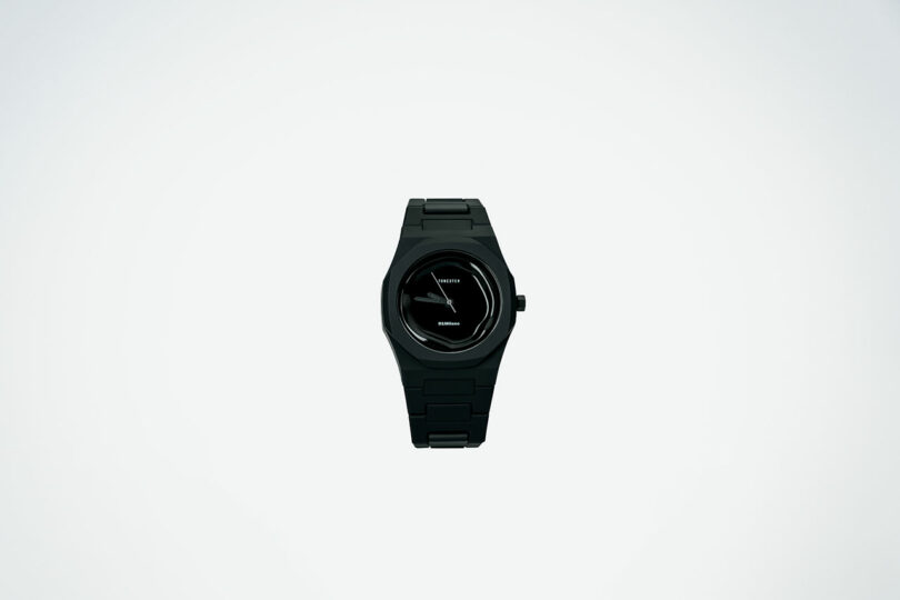 A black wristwatch with a simple, minimalistic design is centered on a plain white background.