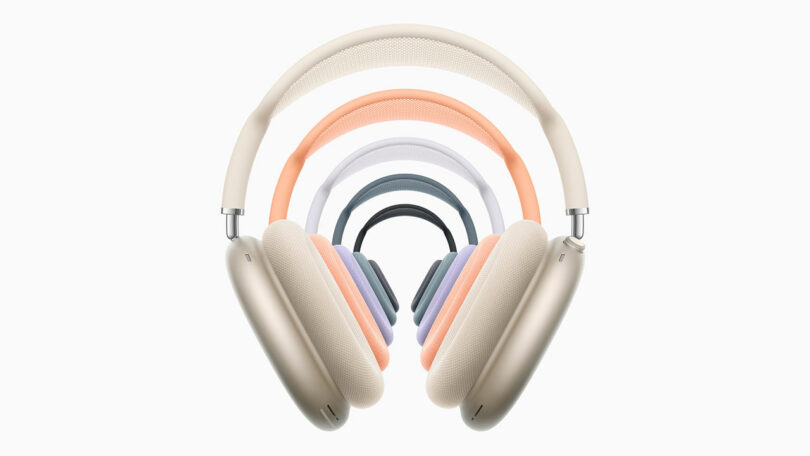A display of AirPods Max 2 over-ear headphones in five different colors—beige, orange, purple, blue, and green—arranged in a layered pattern against a white background.