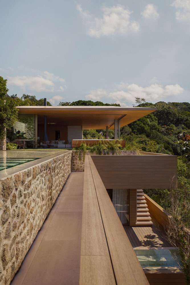 arthur casas adapts speculative structure into wood-lined coastal house in brazil