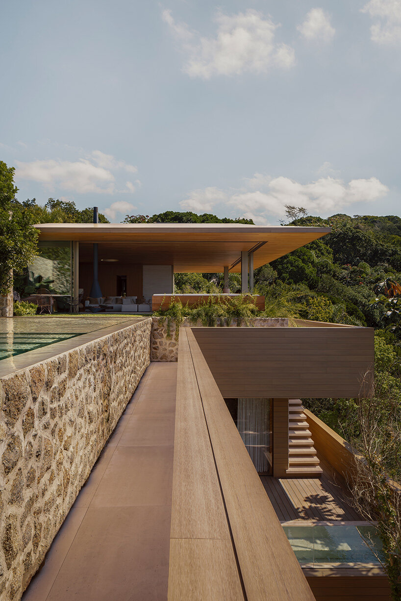 arthur casas adapts speculative structure into wood-lined coastal house in brazil - 4