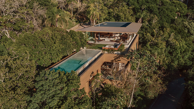 arthur casas adapts speculative structure into wood-lined coastal house in brazil - 1