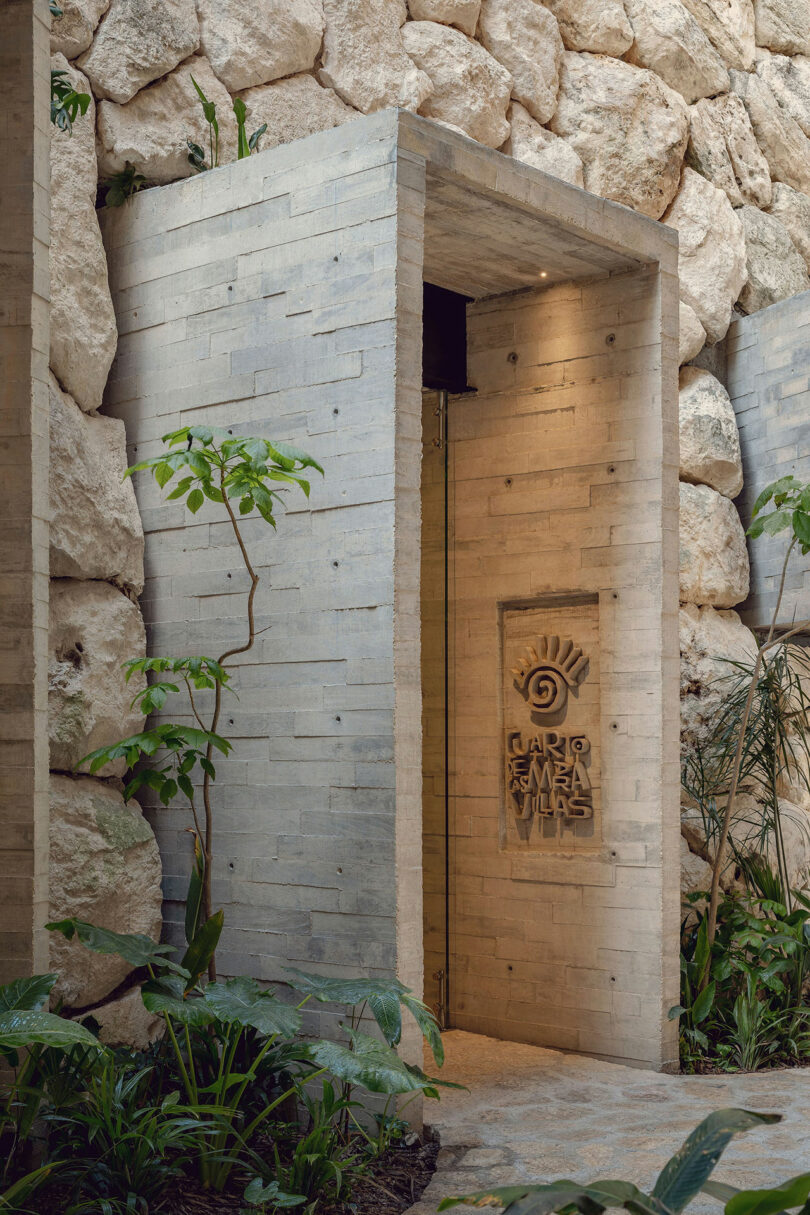 A modern stone entryway with a sign reading 