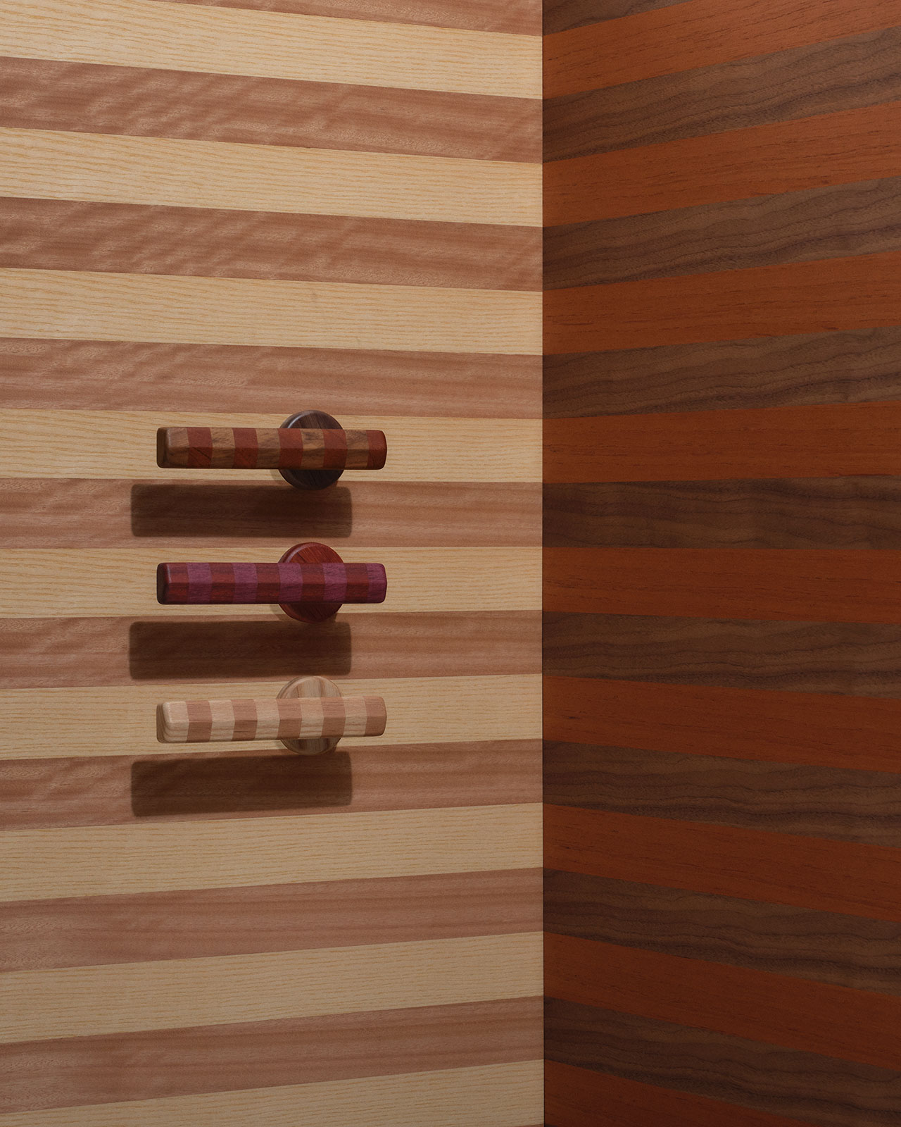 Three cylindrical wooden hooks are mounted on a striped wood wall in a corner, each hook featuring a different shade and grain pattern.