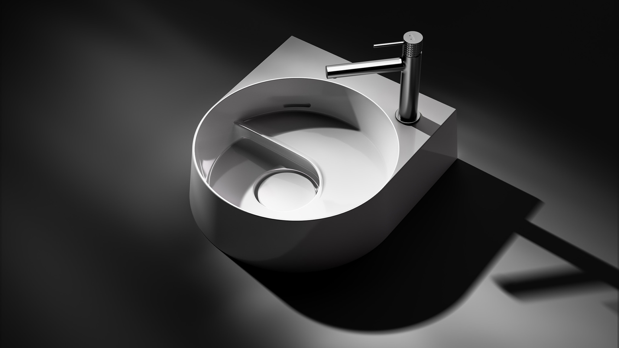 Modern white circular sink with a spiral groove design and a sleek, metallic faucet, photographed on a dark background with dramatic lighting and shadows.