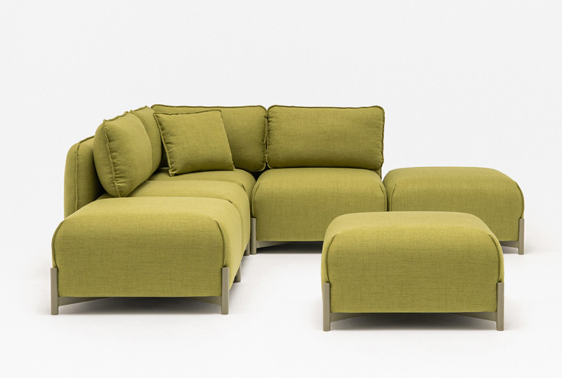 A modern olive-green sectional sofa with three seat cushions, matching back cushions, and two ottomans on a white background.