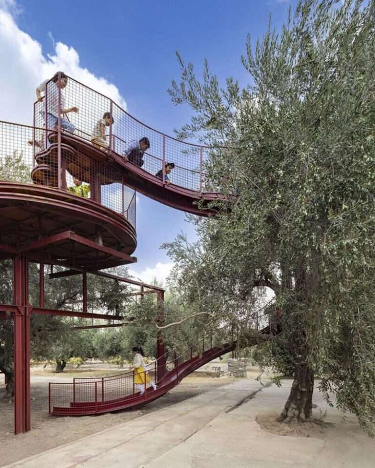 ZAV architects weaves a modular yellow playground through an olive orchard in iran