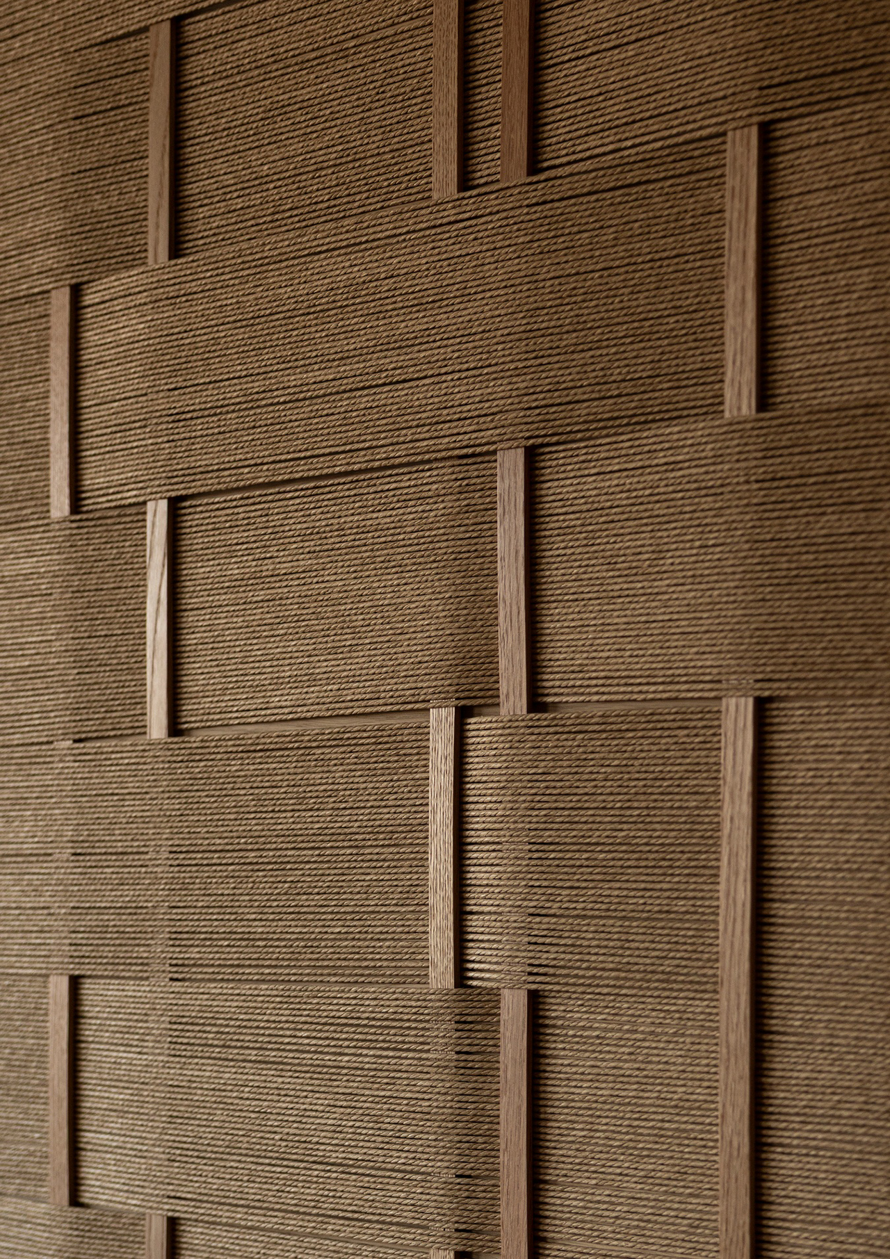 Close-up of a brown textured surface showing an interwoven pattern of flat, horizontal and vertical strips, reminiscent of designs by Norm Architects.