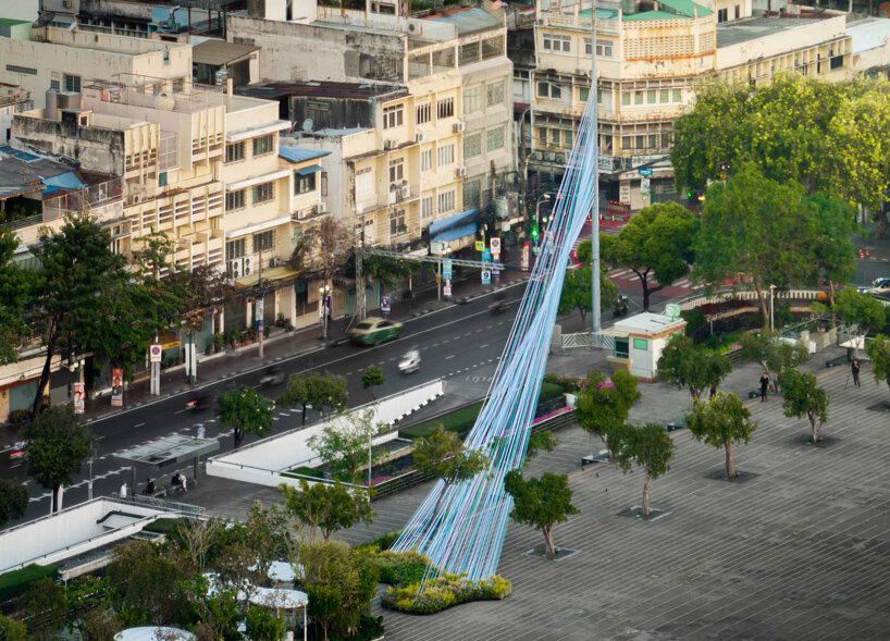recyclable fabric ribbons weave between bangkok&rsquo;s streetlights into colorful urban canopy - 2