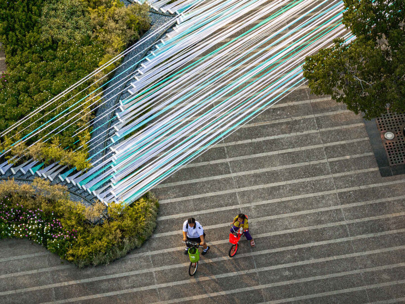 recyclable fabric ribbons weave between bangkok&rsquo;s streetlights into colorful urban canopy - 4