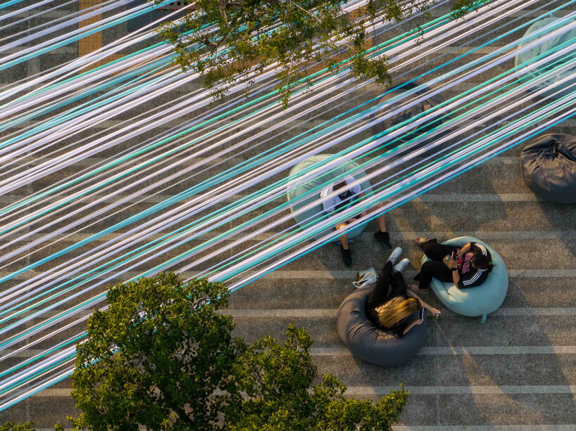 recyclable fabric ribbons weave between bangkok&rsquo;s streetlights into colorful urban canopy - 5