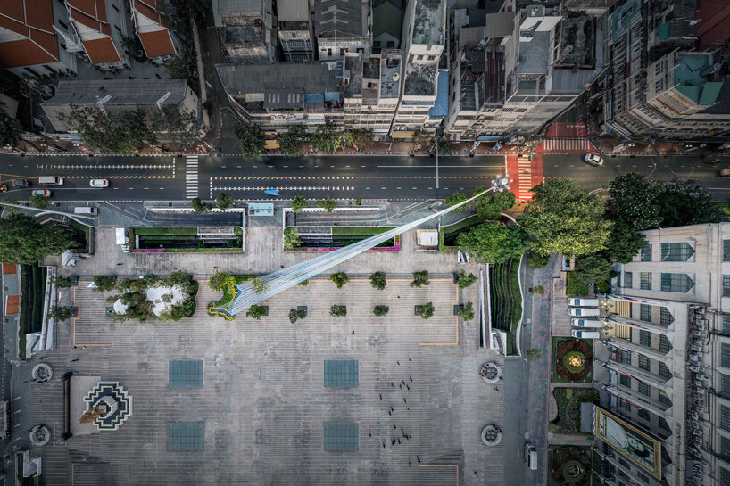 recyclable fabric ribbons weave between bangkok&rsquo;s streetlights into colorful urban canopy - 1
