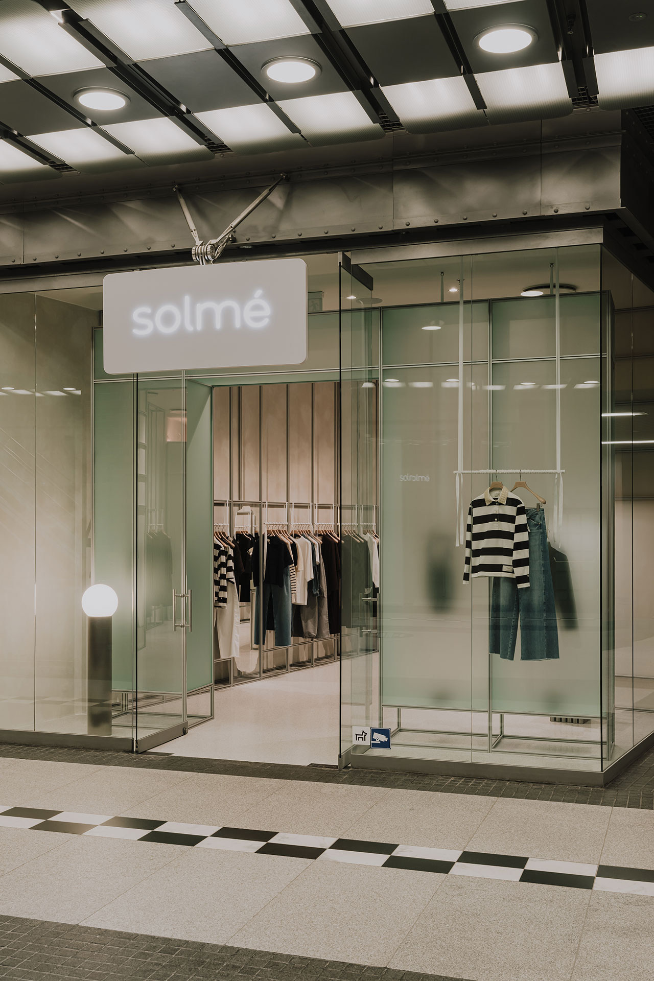 A modern clothing store with a glass storefront labeled 