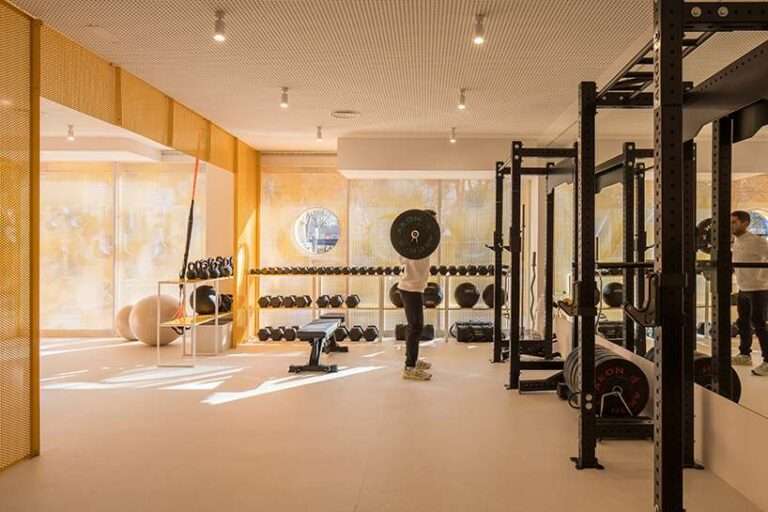 bright orange perforated metal sheets shape a modular fitness center in madrid
