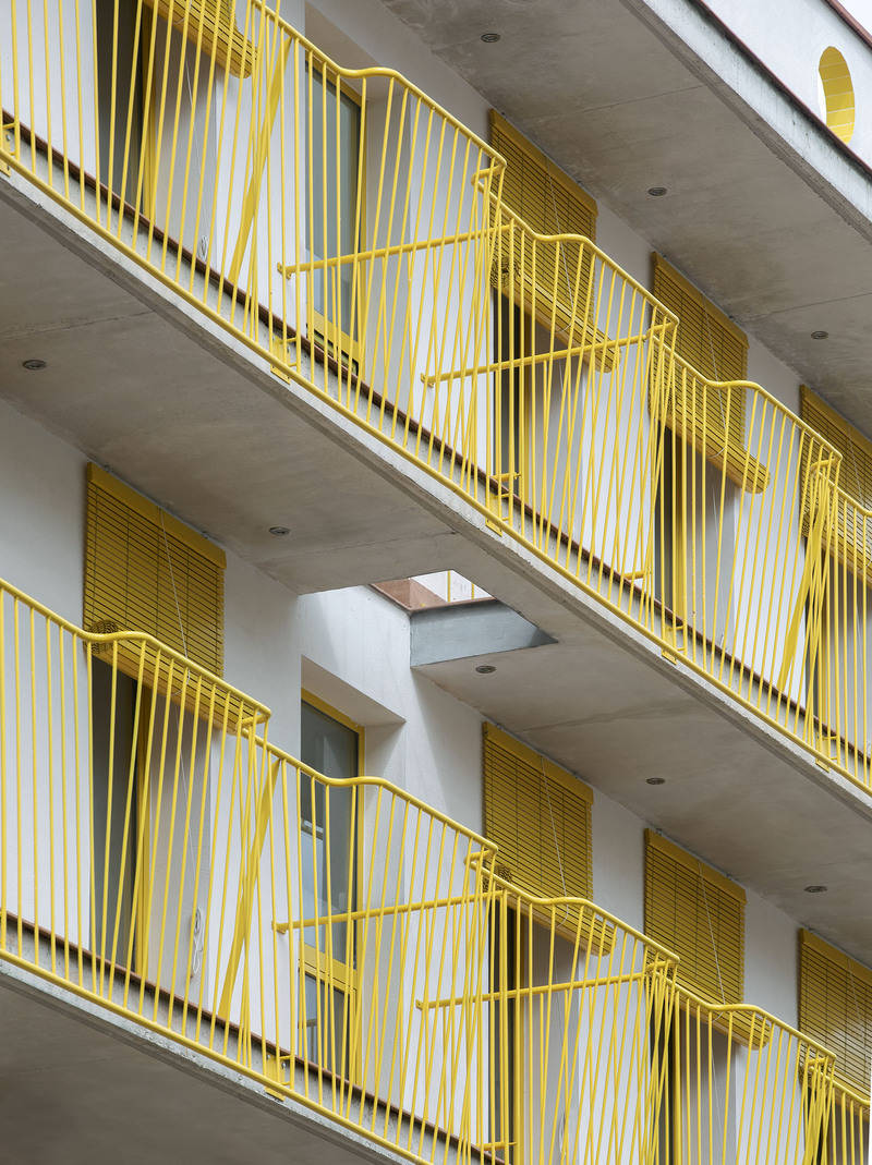 yellow steel, concrete, and circular openings revive corner building in spain as apart-hotel - 2