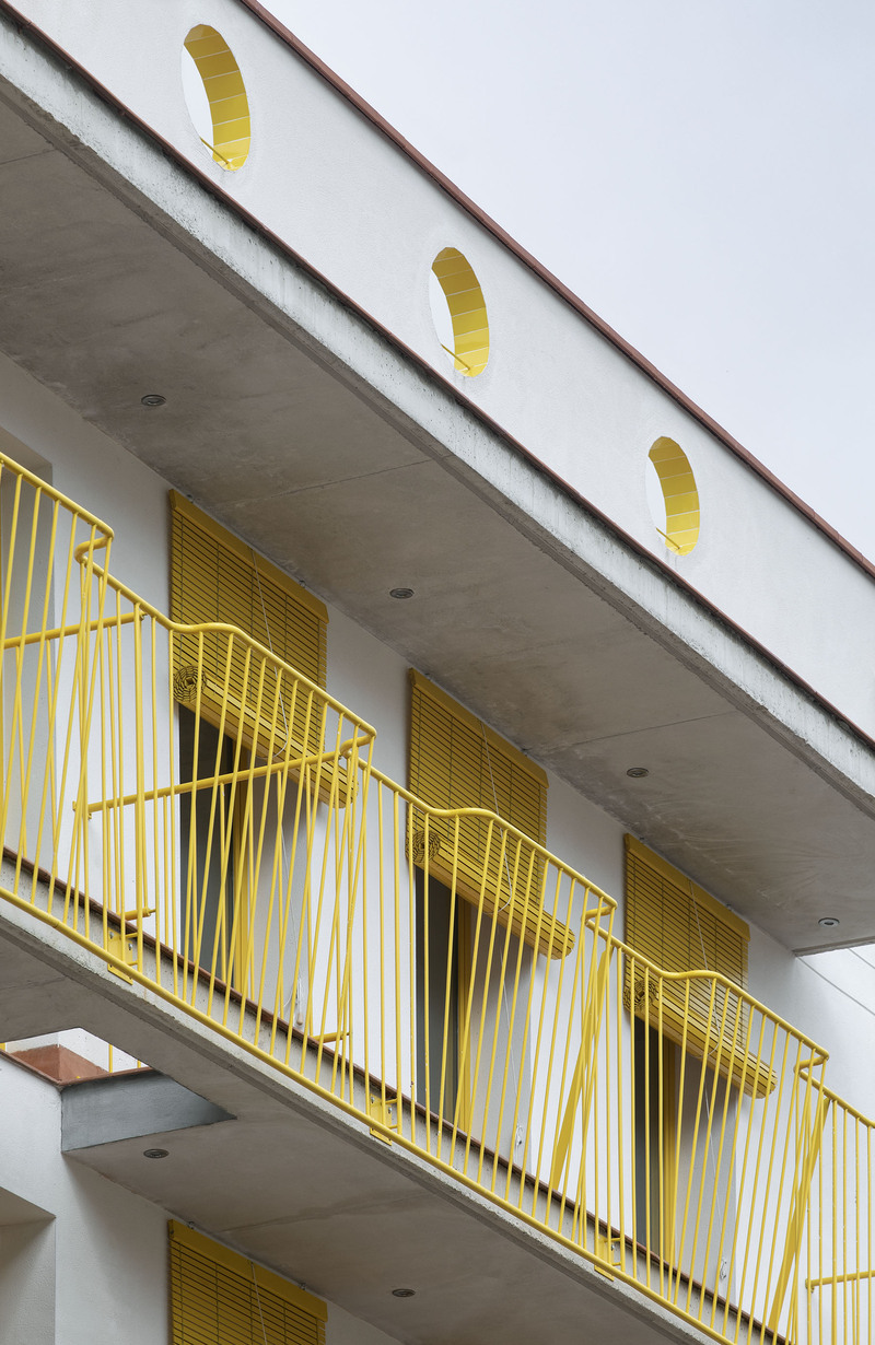 yellow steel, concrete, and circular openings revive corner building in spain as apart-hotel - 3