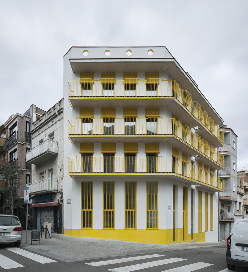 yellow steel, concrete, and circular openings revive corner building in spain as apart-hotel - 1