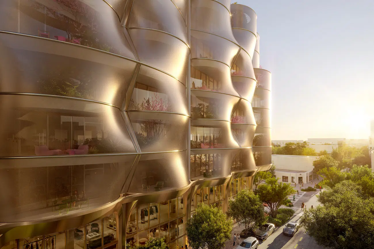 A taut coiled stainless steel mesh veil shades the office balconies and provides thevisual identity of the building. 